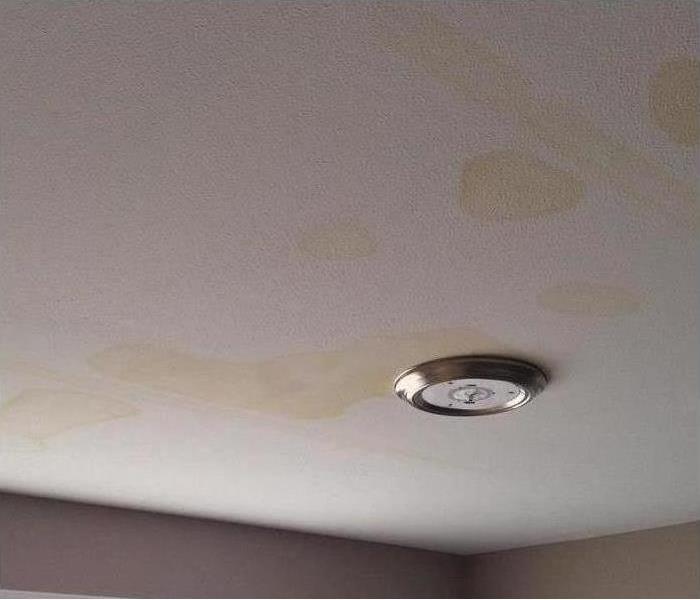 water spots indicating damage on ceiling after a storm