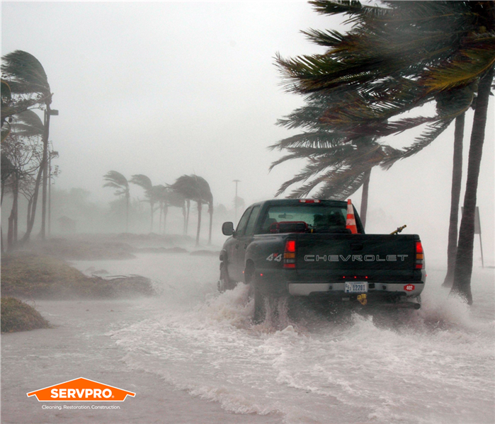 Truck driving through flooded streets during a hurricane in Northwest Orlando, SERVPRO of Northwest Orlando logo