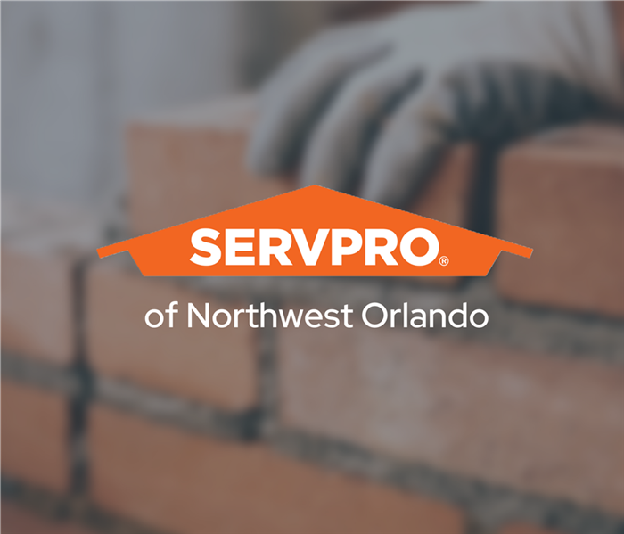 SERVPRO of Northwest Orlando workers construct a red brick wall after a disaster near me
